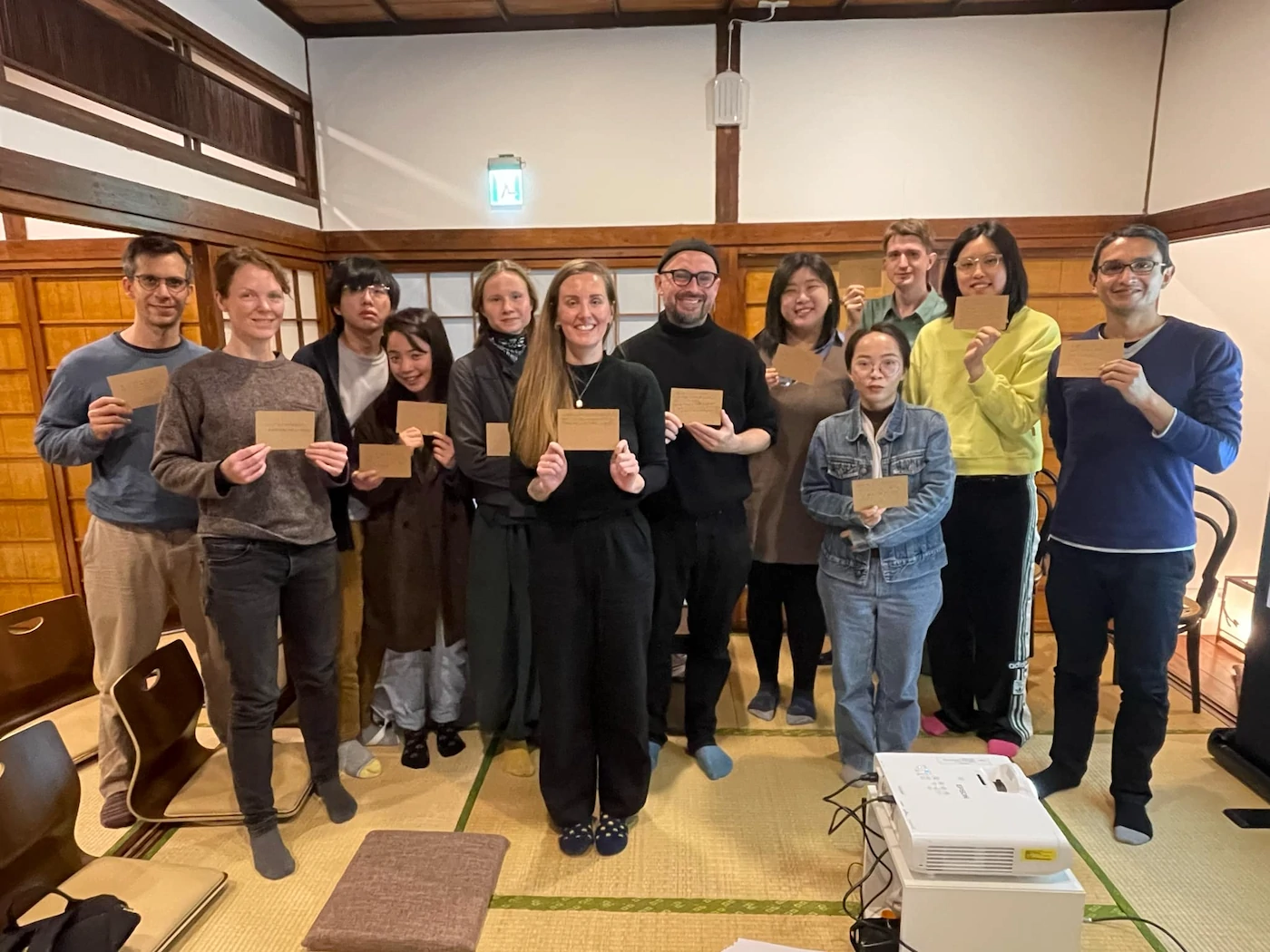 A group of writers, holding postcards